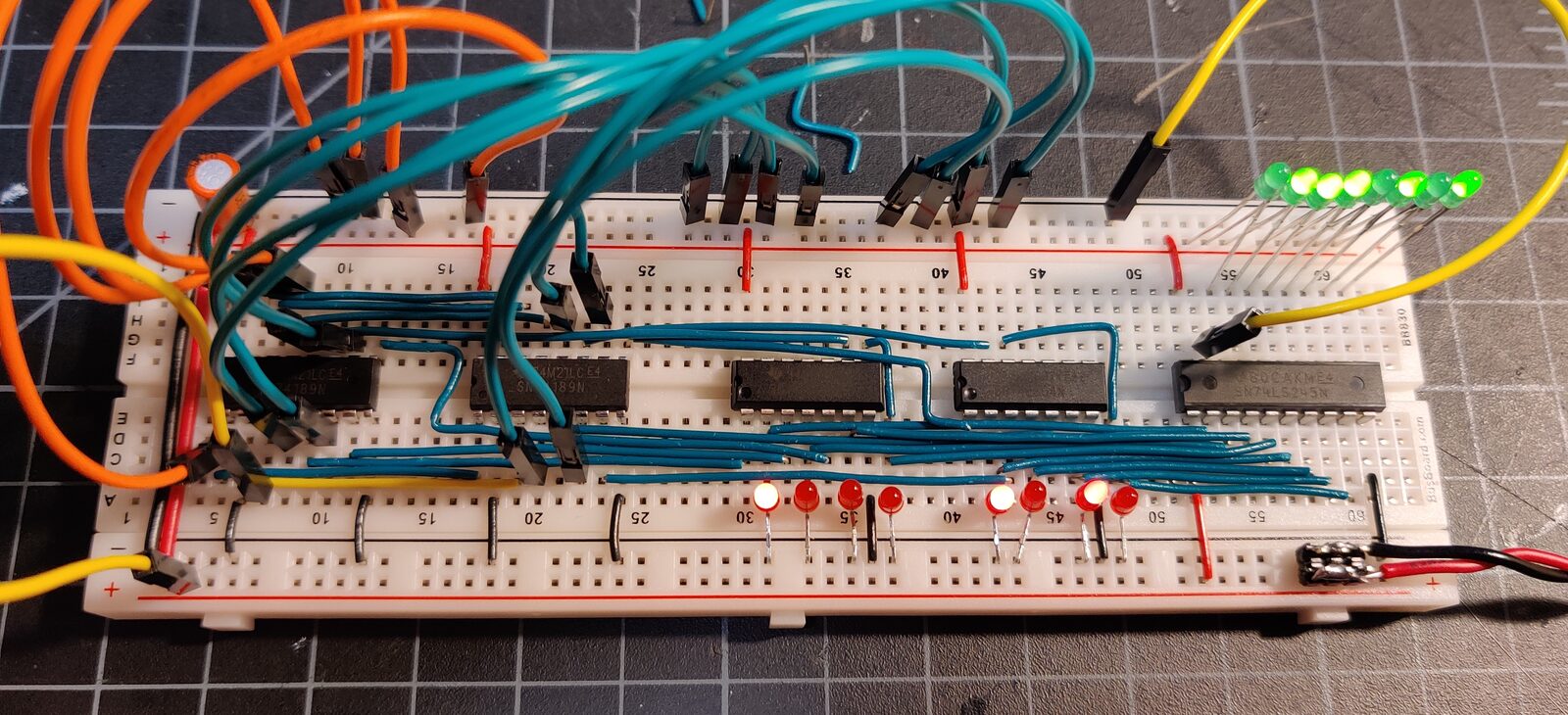 The 8-bit CPU on breadboards, chips and jumper wires with a row of status LEDs