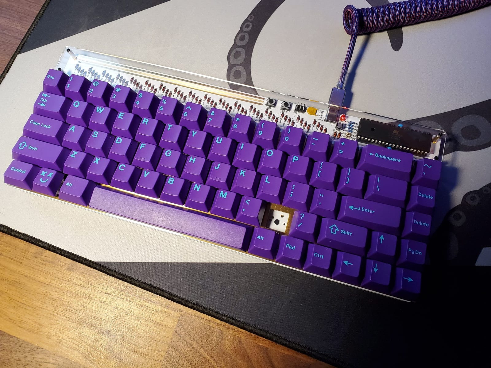 Custom keyboard in a clear acrylic case, showing the PCB and switches