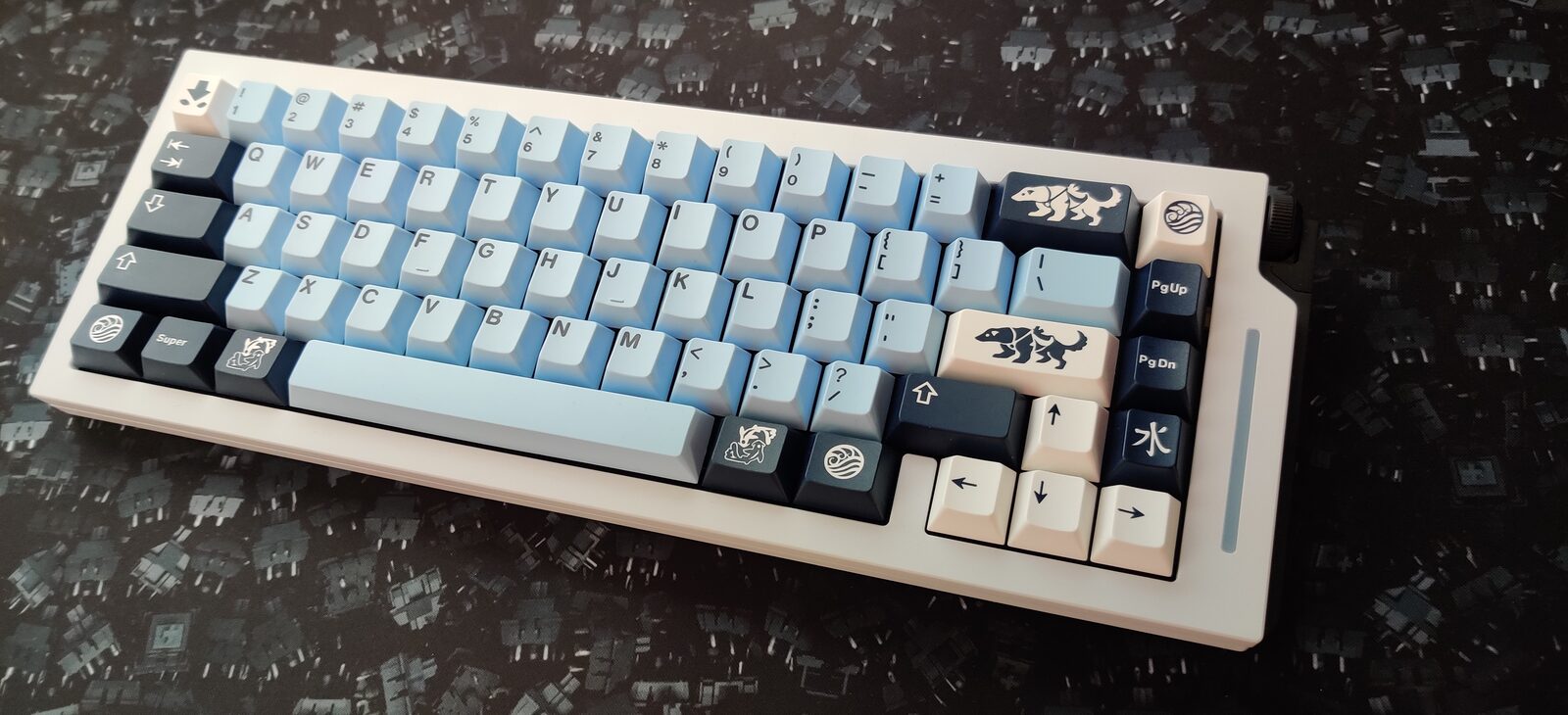 Custom mechanical keyboard with cream and blue keycaps and artisan accents