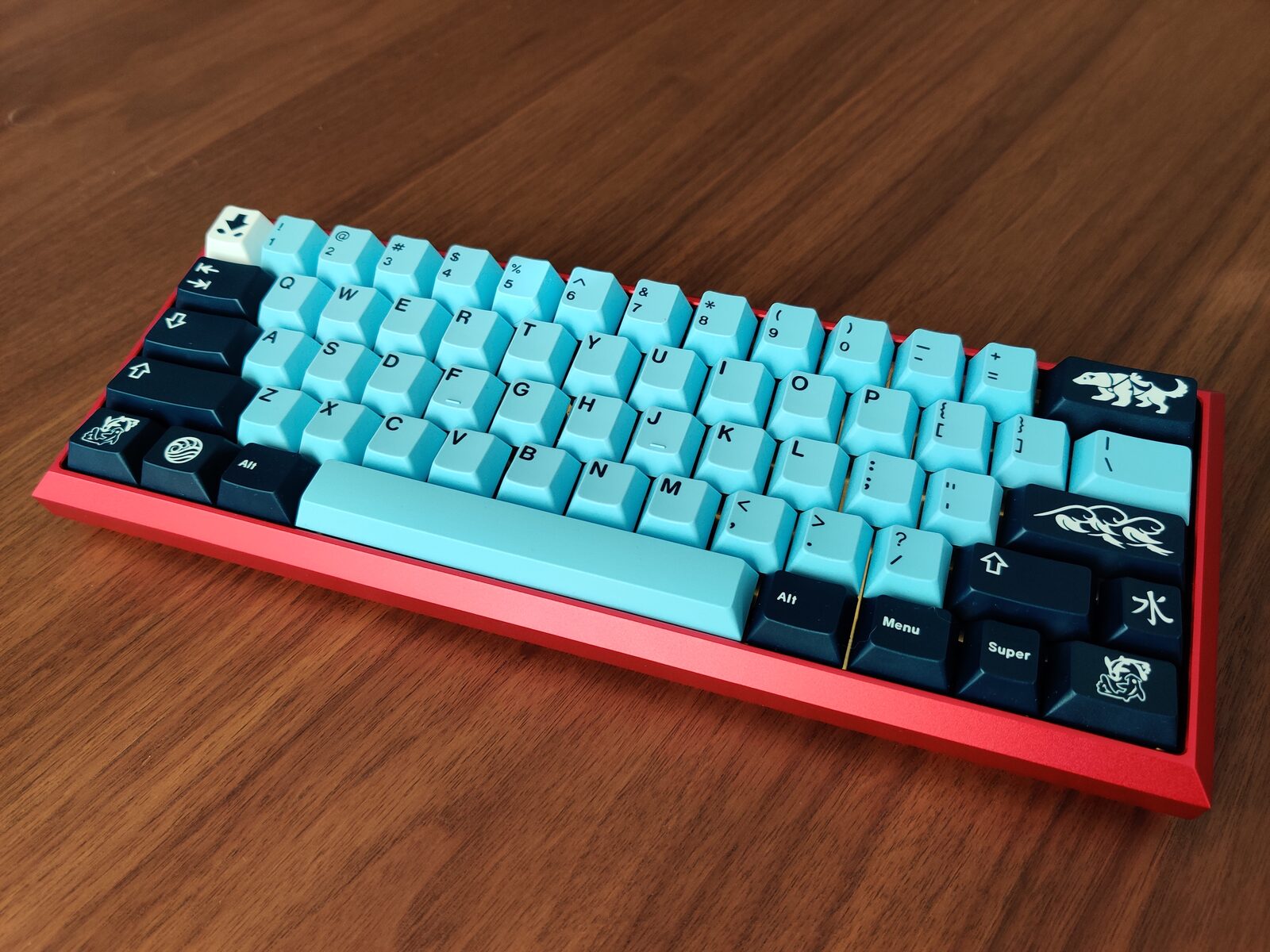 Custom mechanical keyboard, teal keycaps on a red aluminum case
