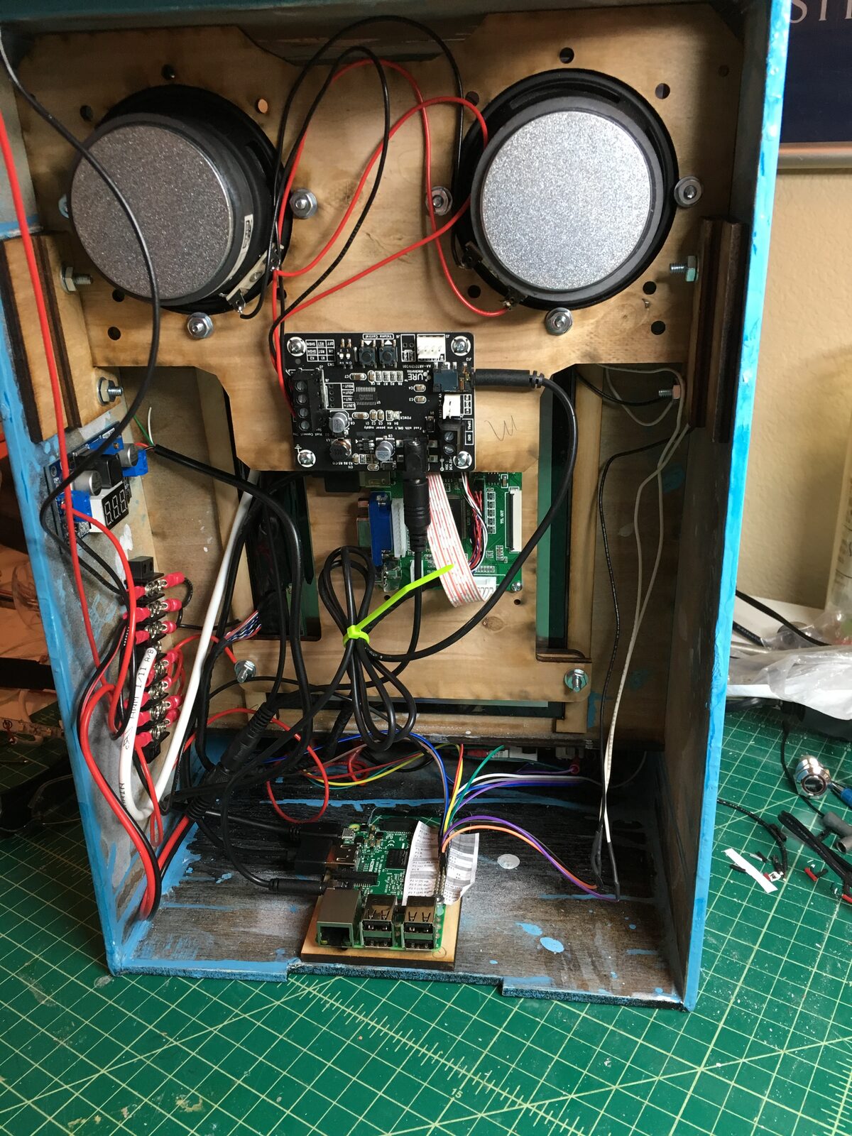 Inside the finished cabinet, the Raspberry Pi, speakers, and RGB button wiring