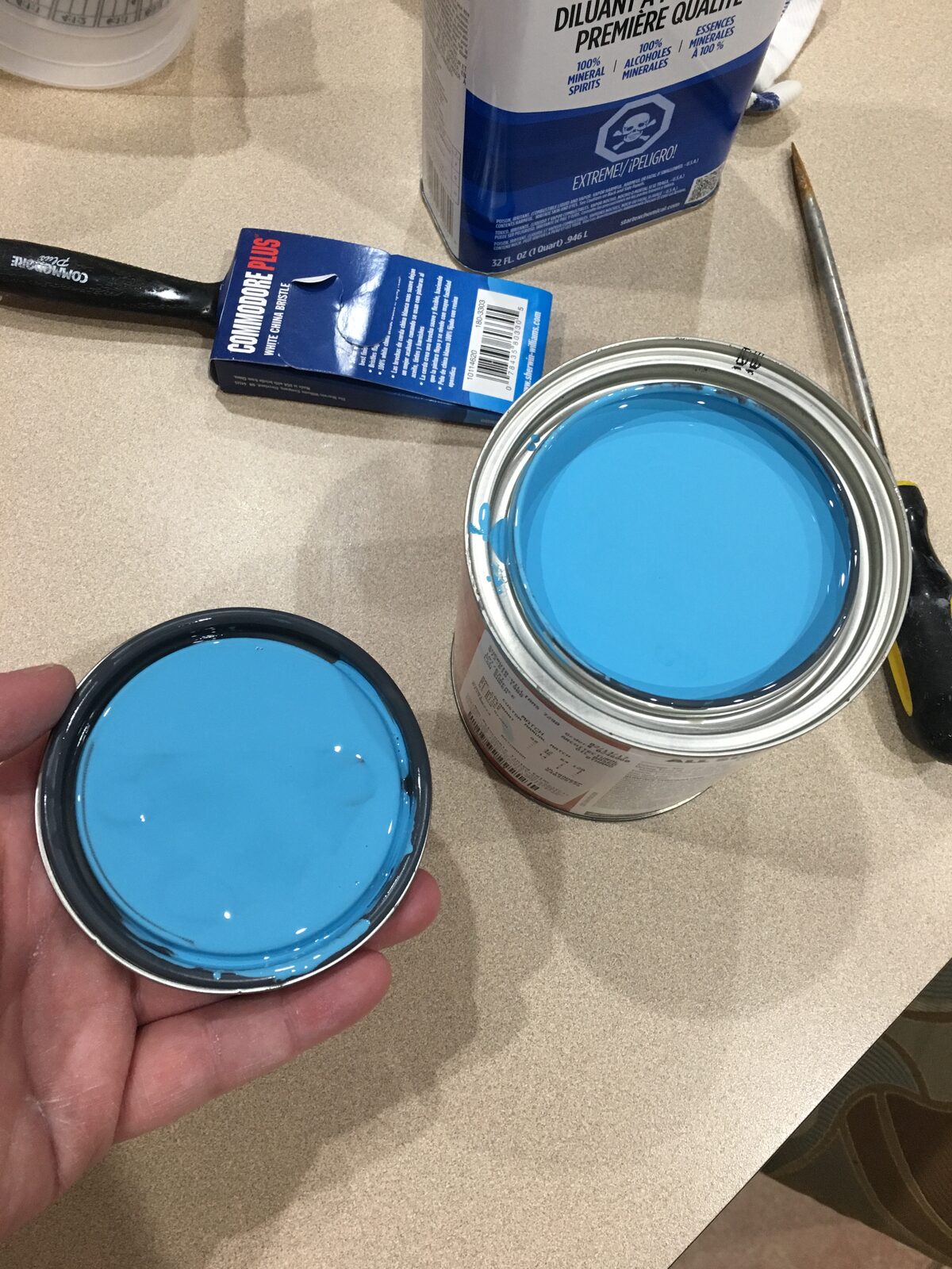 Mixing the bright blue paint for the cabinet