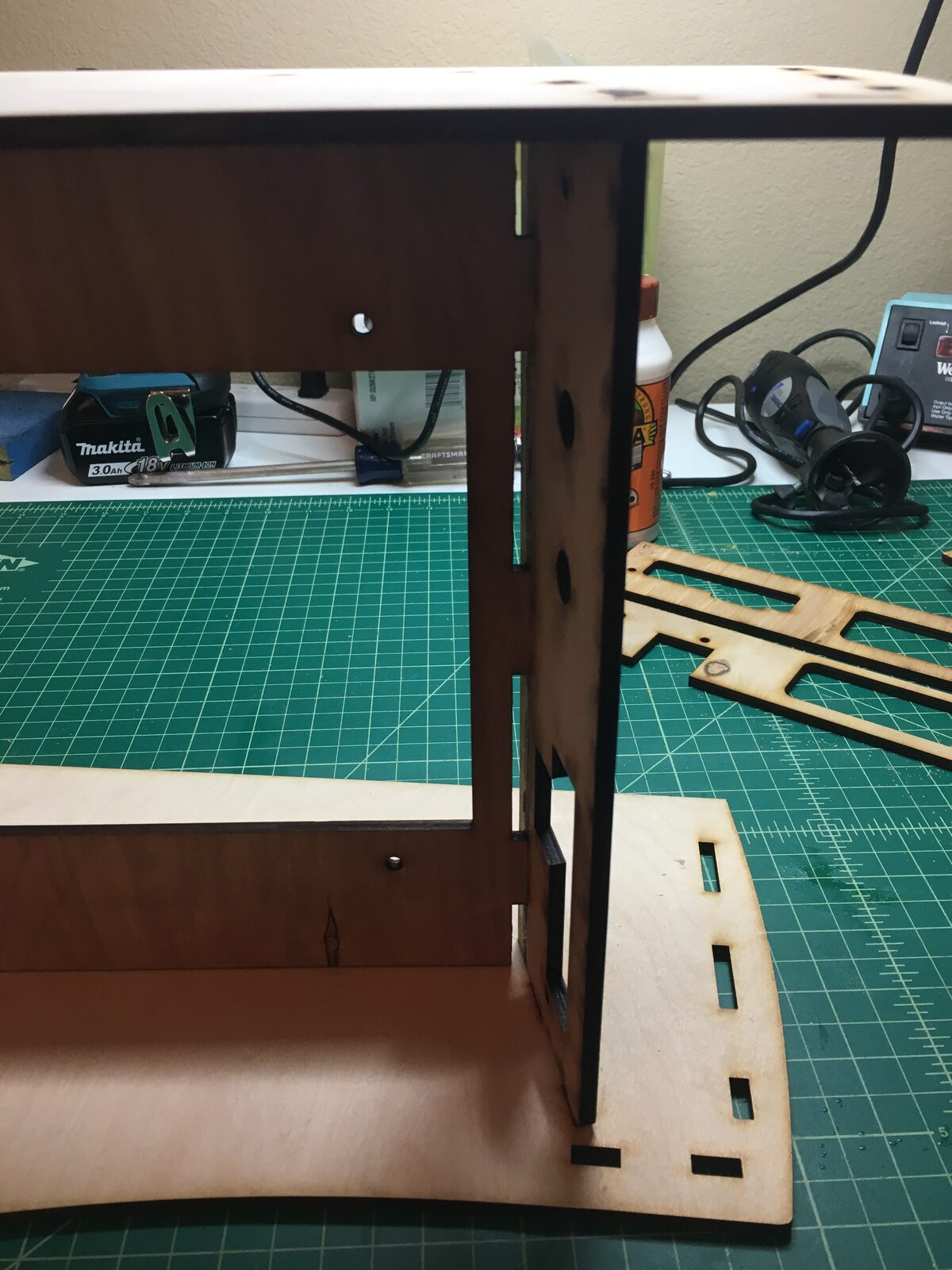 The laser-cut flat-pack cabinet panels on a cutting mat before assembly