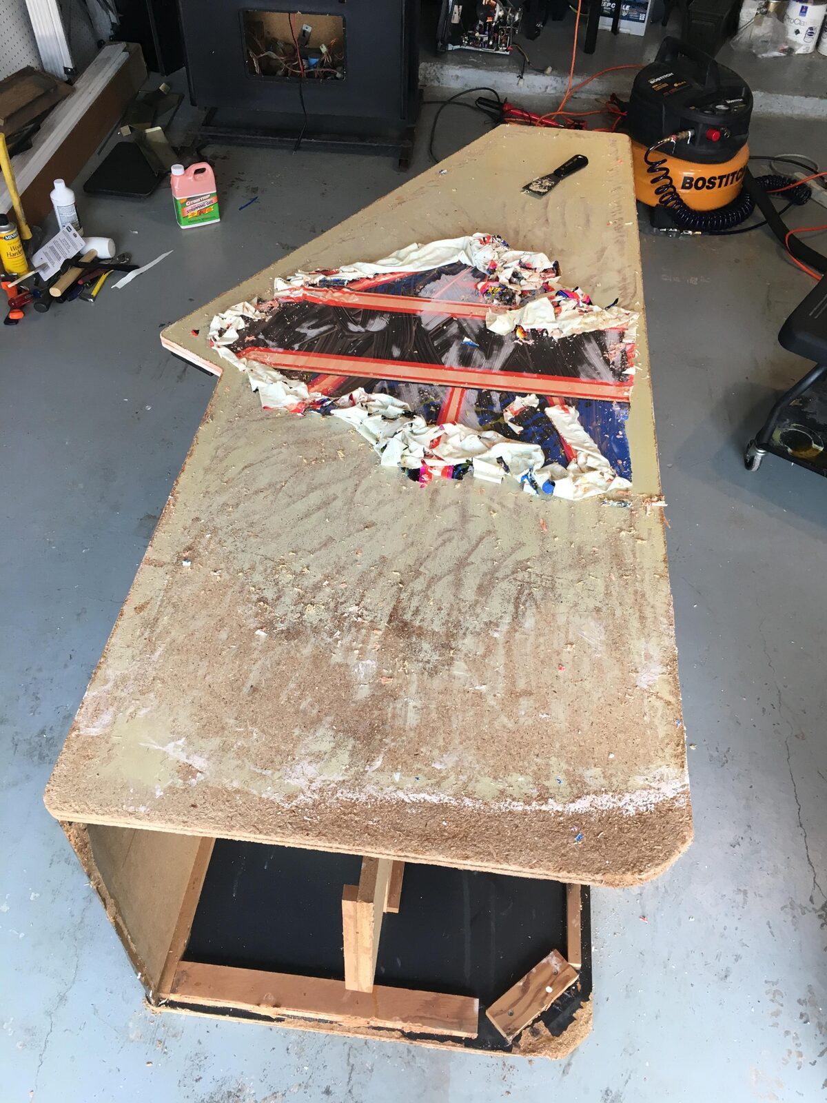 A cabinet panel sanded back to bare particleboard