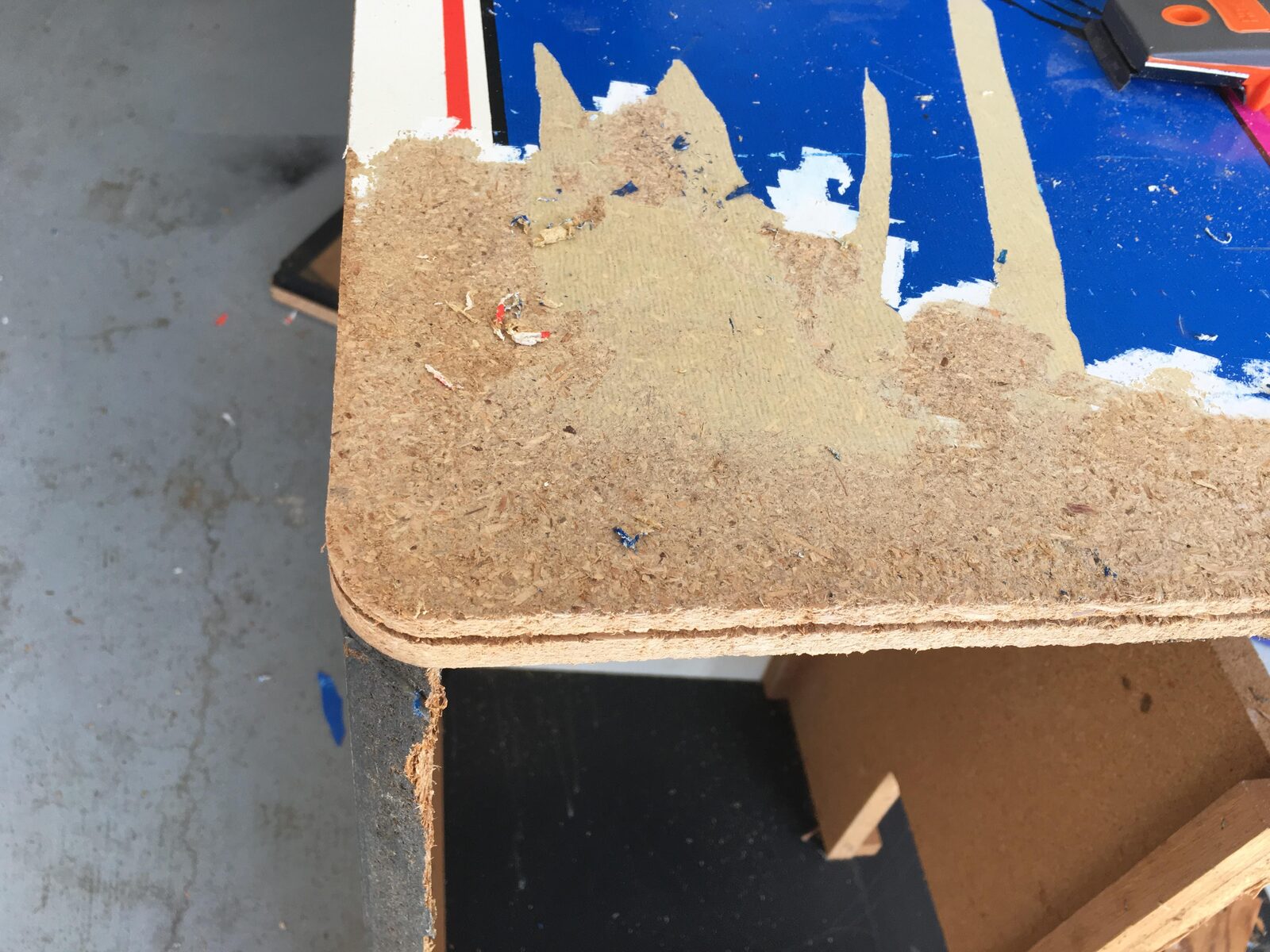 Scraping the old artwork off a cabinet side panel