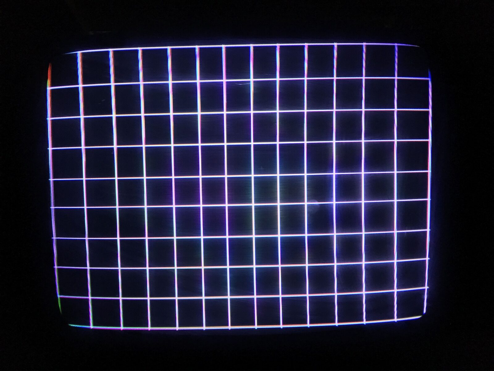 The rebuilt Wells-Gardner WG6100 vector monitor showing a clean crosshatch