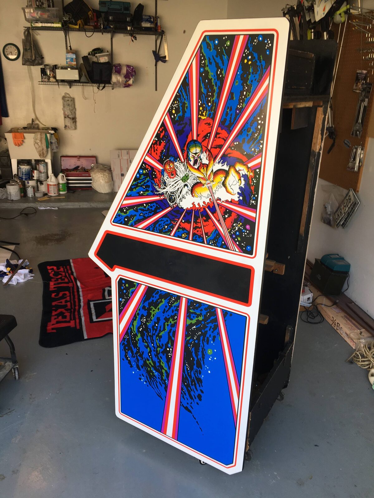 The restored cabinet standing with fresh reproduction Tempest side art