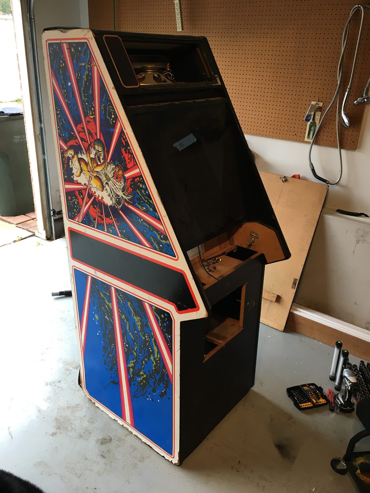The Tempest cabinet torn down, original worn side art and boards pulled
